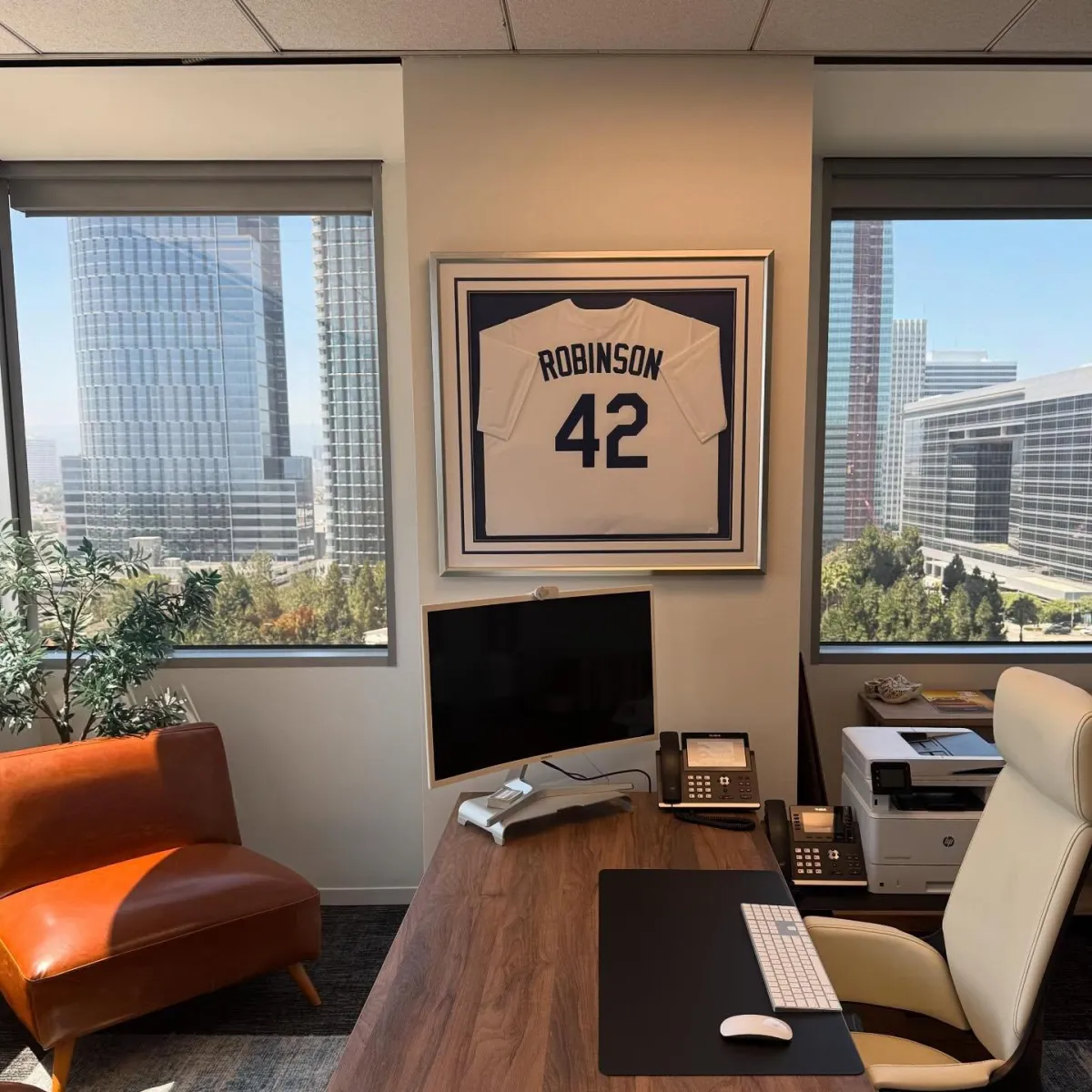 Custom framed Robinson 42 baseball jersey displayed in a professional office