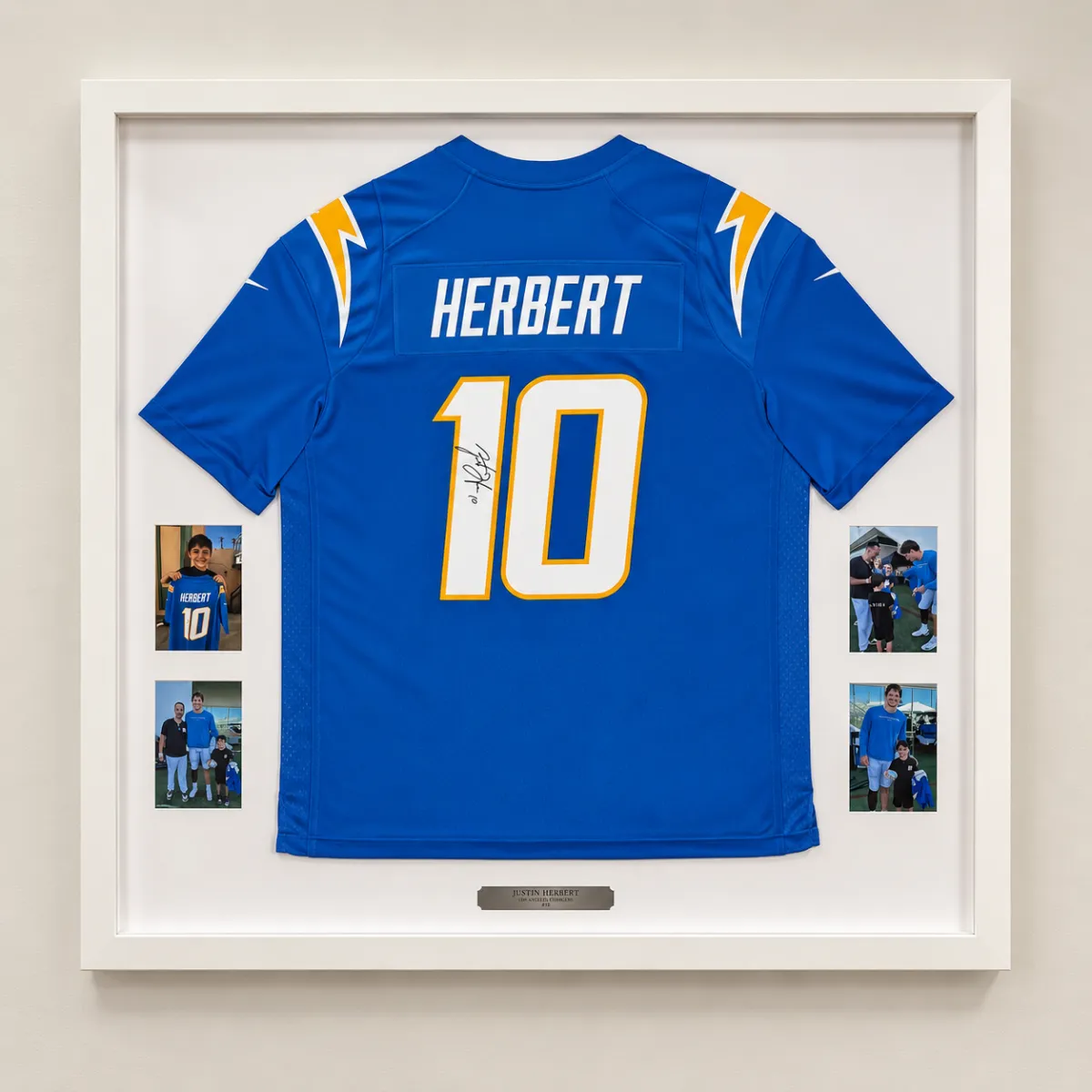 Custom framed Justin Herbert football jersey with autograph, photos, and personalized memorabilia display