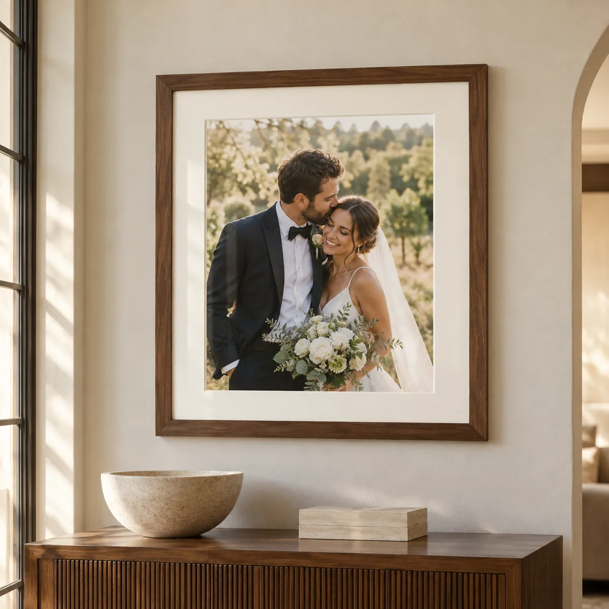 wedding portrait in a custom walnut frame with an ivory mat, displayed in a refined home interior.