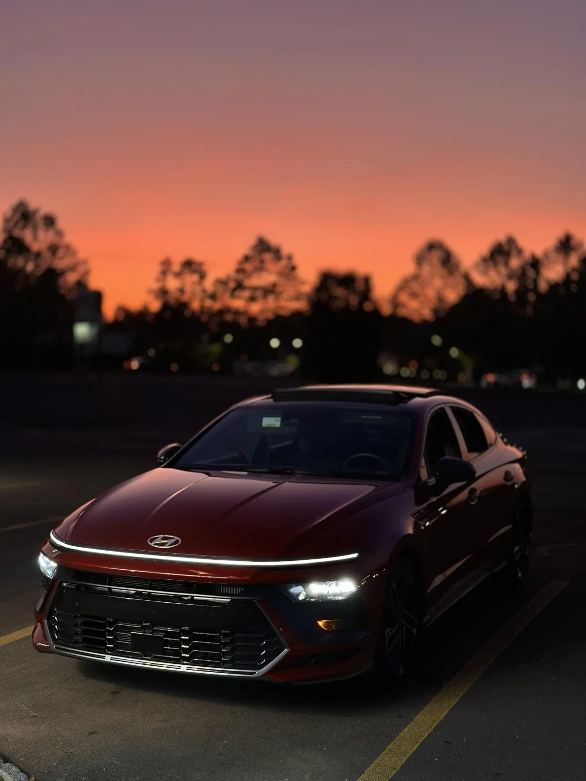 White Corvette with roof down and white Mercedes in the background