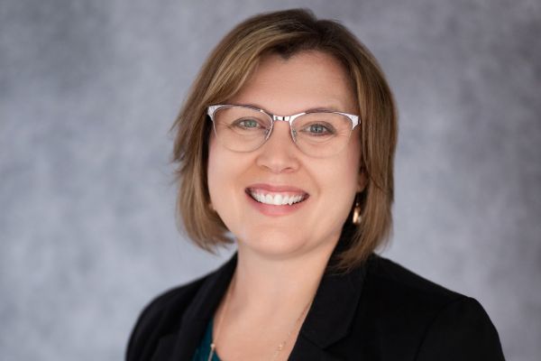 Portrait of Amy McNair against a light blue background