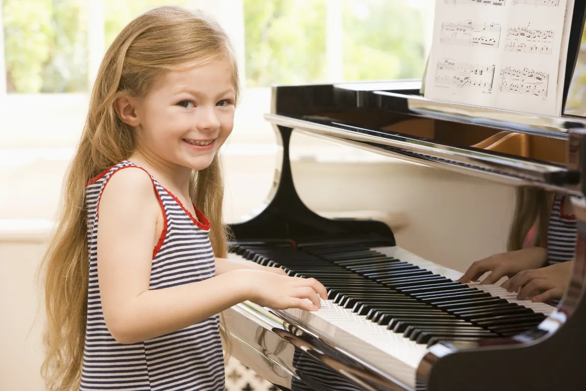 Teen piano student at a Nordiska upright piano during a private lesson at a Farmington, Utah music school.