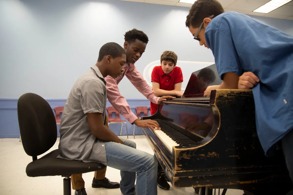 Teen piano student at a Nordiska upright piano during a private lesson at a Farmington, Utah music school.