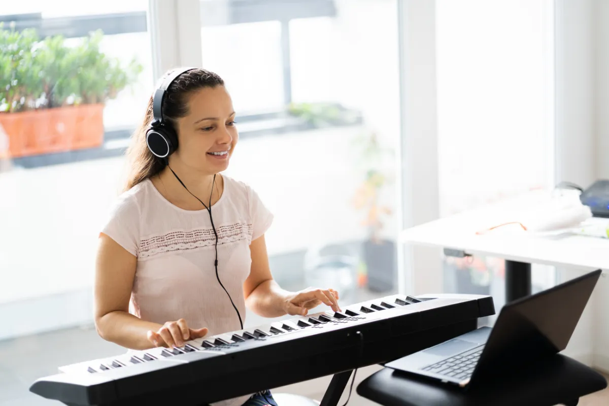 Teen piano student at a Nordiska upright piano during a private lesson at a Farmington, Utah music school.