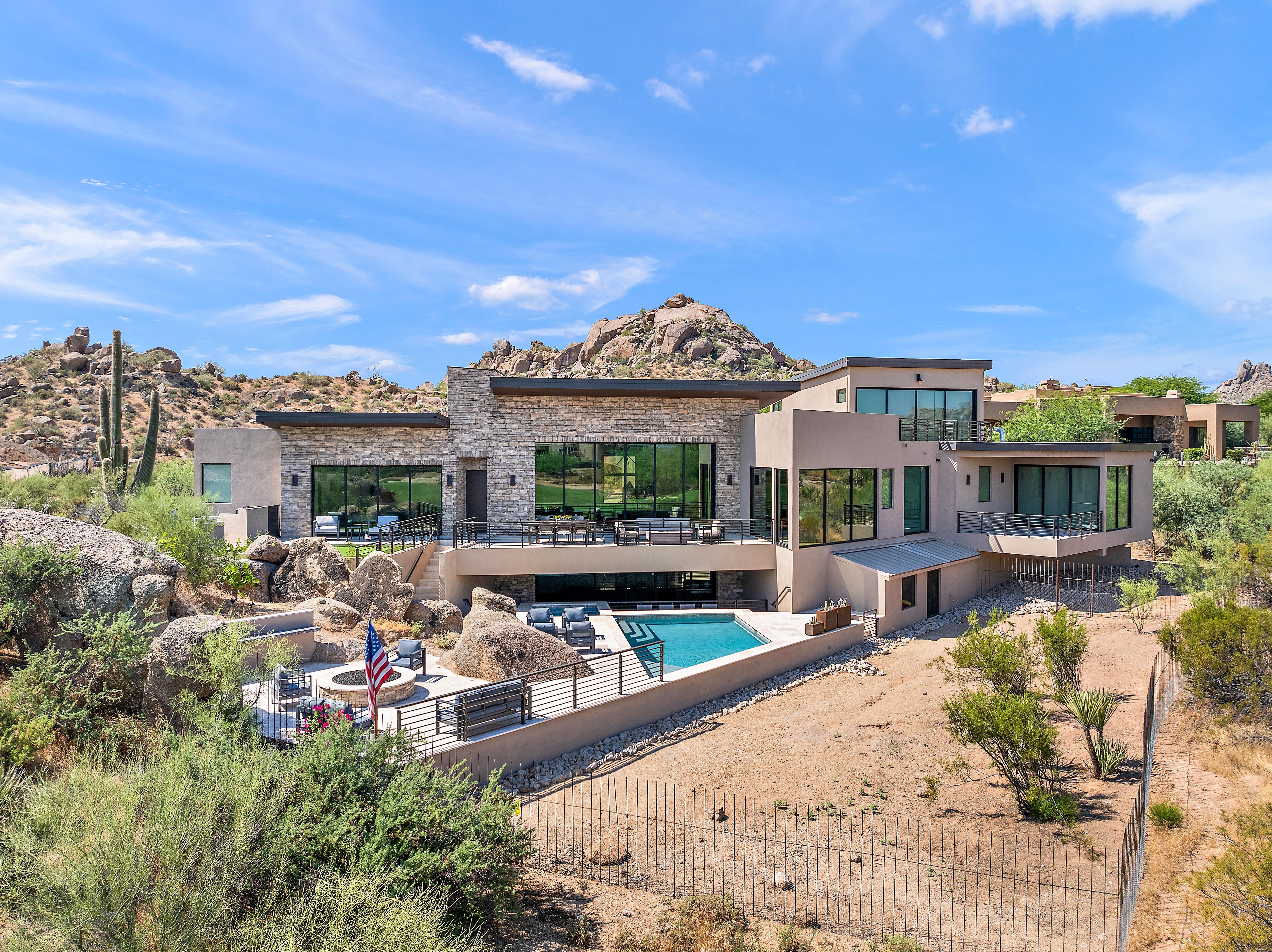 Luxury Arizona desert home with pool, fire pit, and natural rock landscaping — N&M Home Services serving DC Ranch, Troon, and North Scottsdale AZ