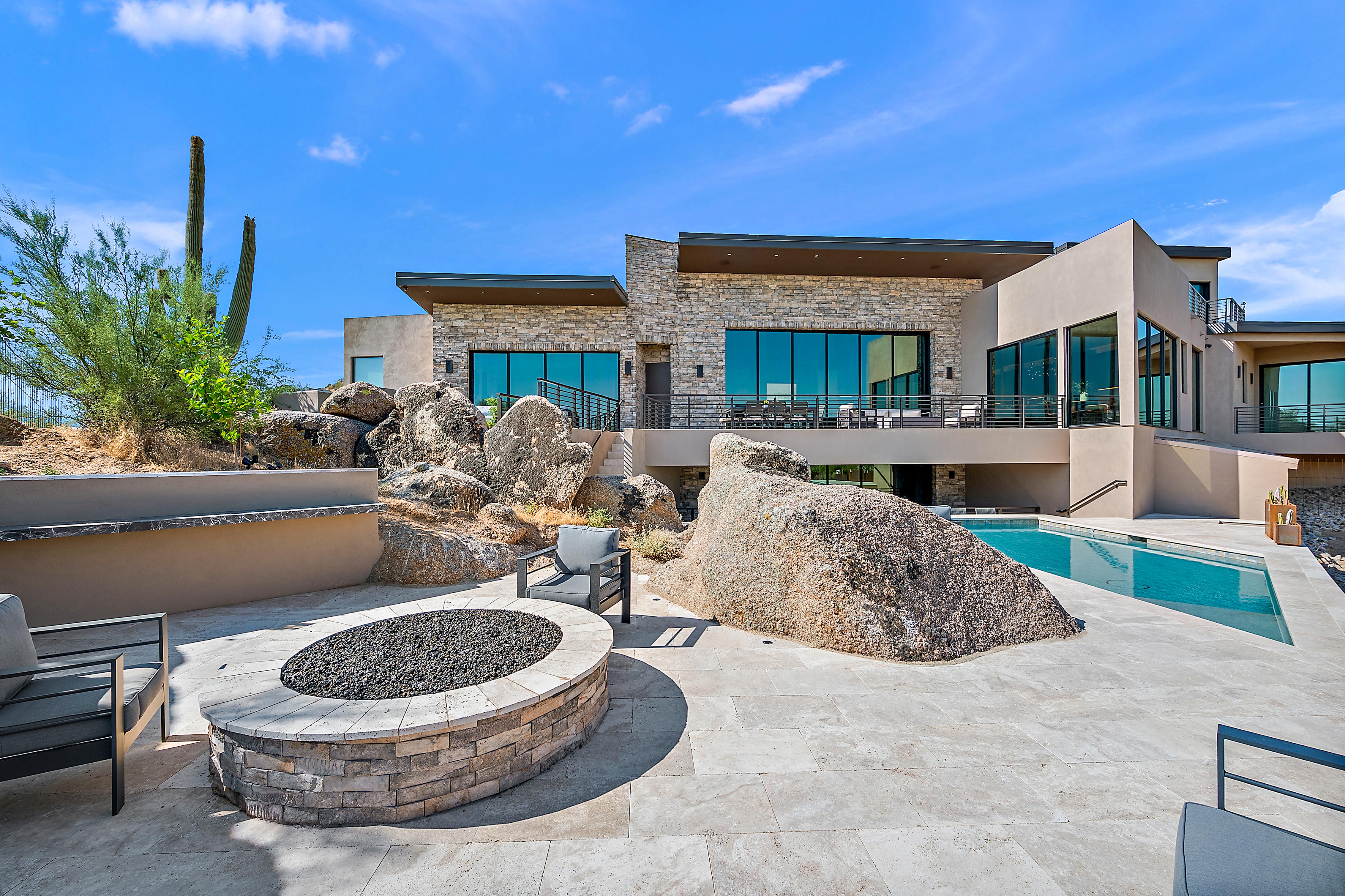 Resort-style pool and spa with artificial turf, mosaic tile spa surround, lounge chairs, and Sonoran desert mountain backdrop — N&M Home Services, Cave Creek and Carefree AZ