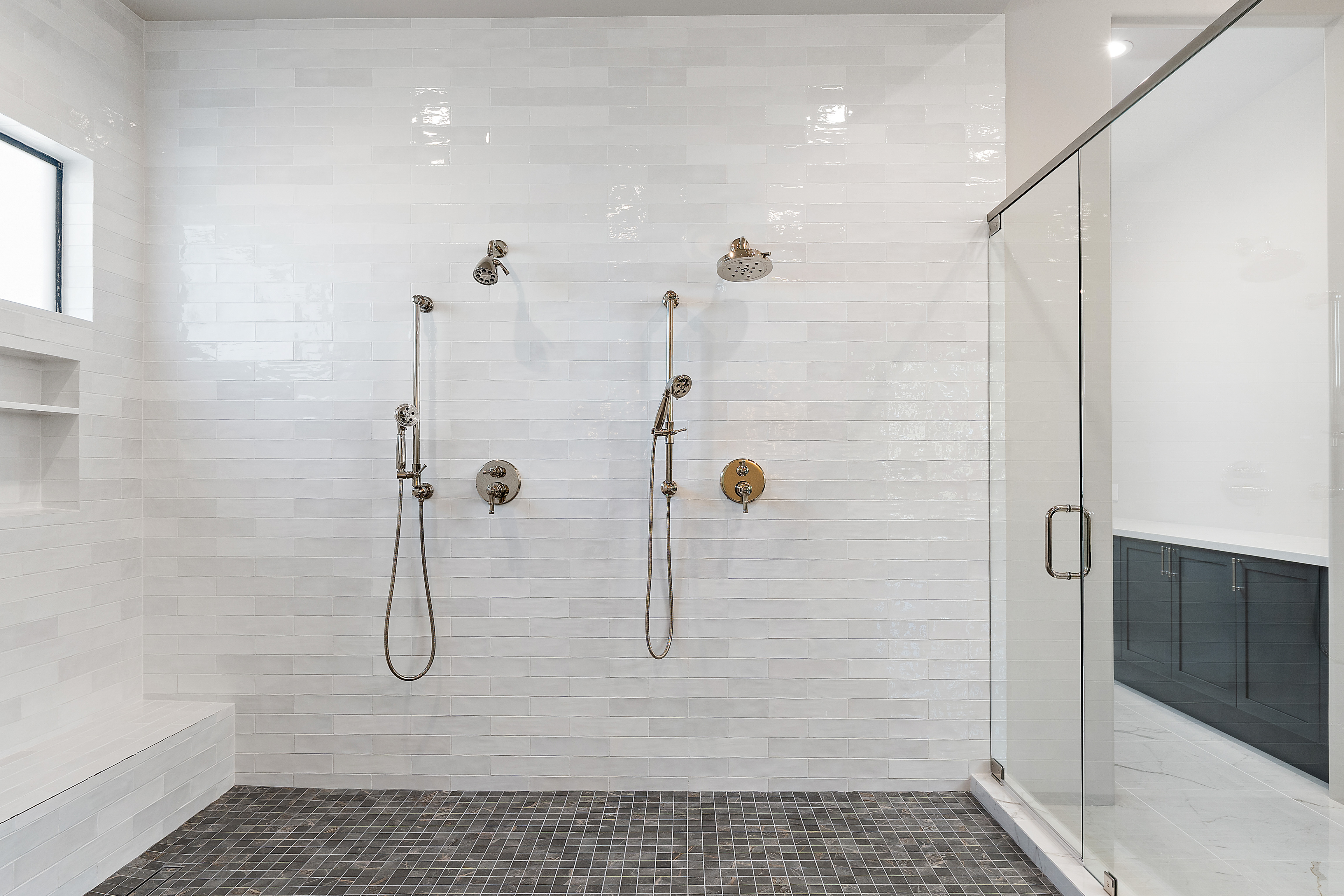 Oversized walk-in shower with dual shower fixtures, glossy subway tile, and frameless glass door — N&M Home Services, Paradise Valley AZ
