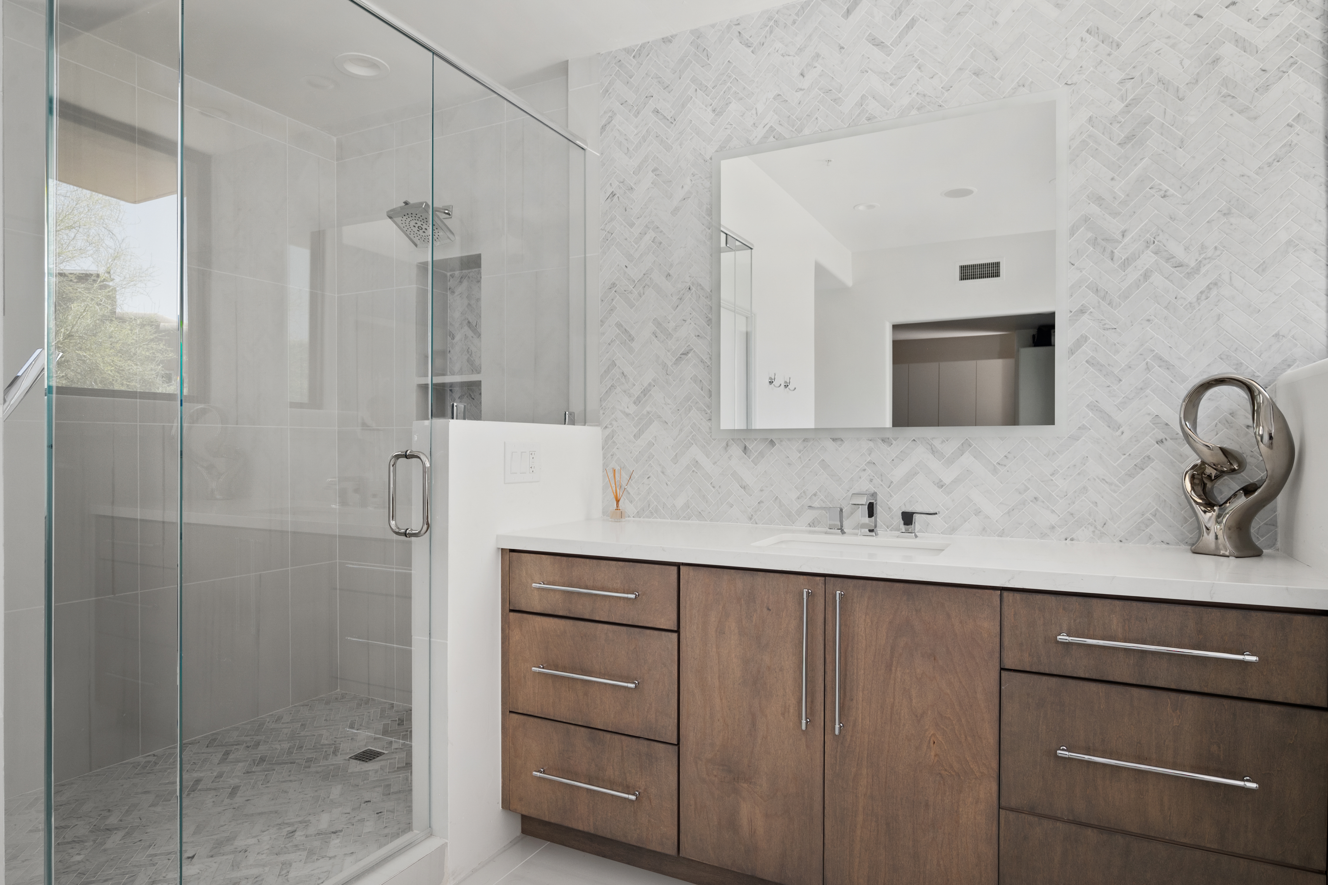 Custom spa shower renovation with dual rainfall shower heads, built-in tile niches, and mosaic stone floor — N&M Home Services, Troon AZ