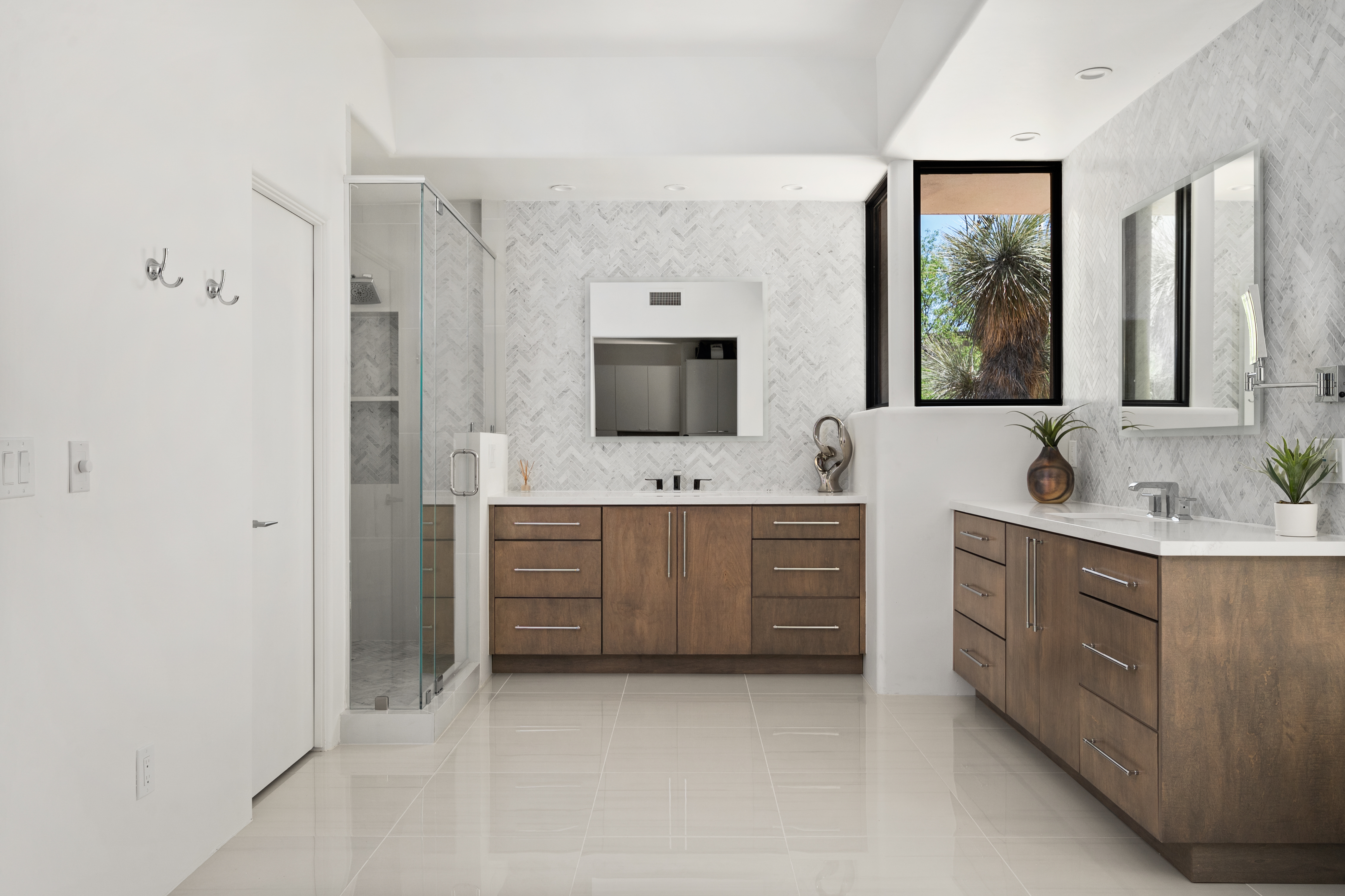 Custom spa shower renovation with dual rainfall shower heads, built-in tile niches, and mosaic stone floor — N&M Home Services, Troon AZ
