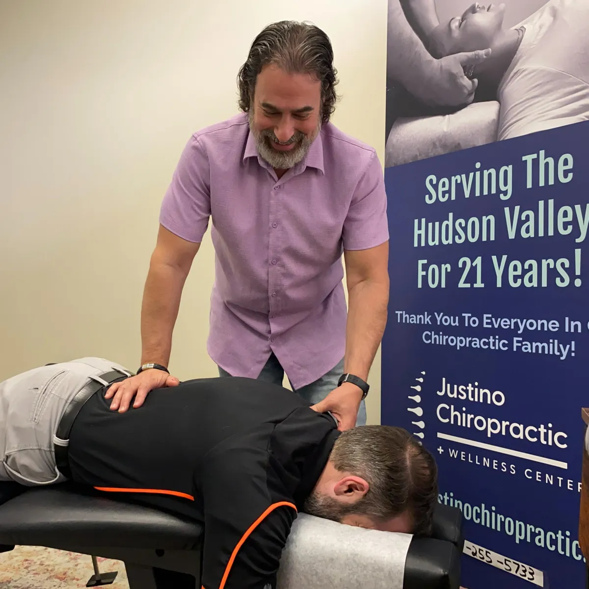 Experienced chiropractor performing a gentle spinal adjustment during a patient visit.