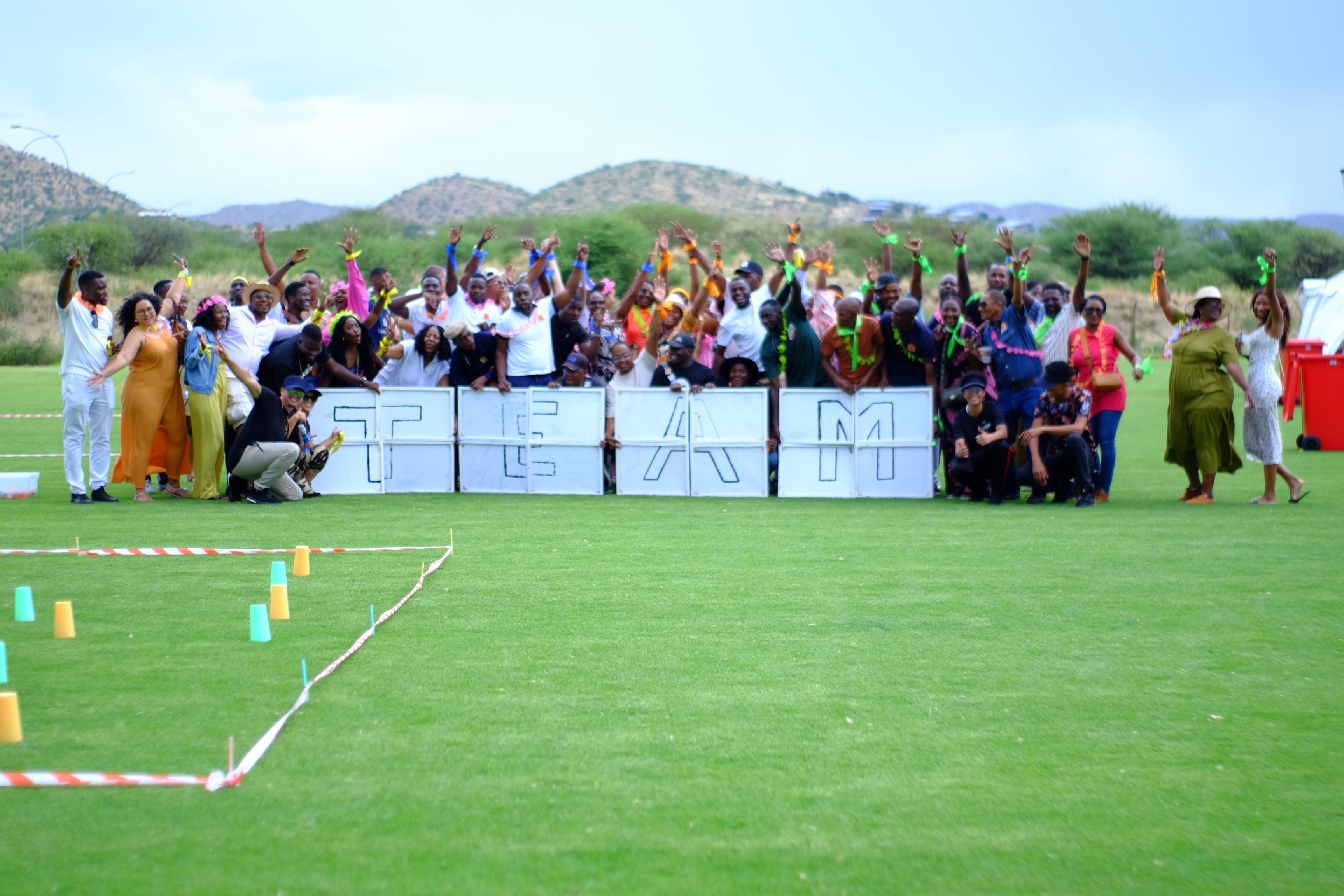 A group of suited professionals in a modern office, seated apart with closed body language and distracted expressions, highlighting disconnection and lack of engagement, shot in a muted, documentary style. 3:2 aspect ratio.