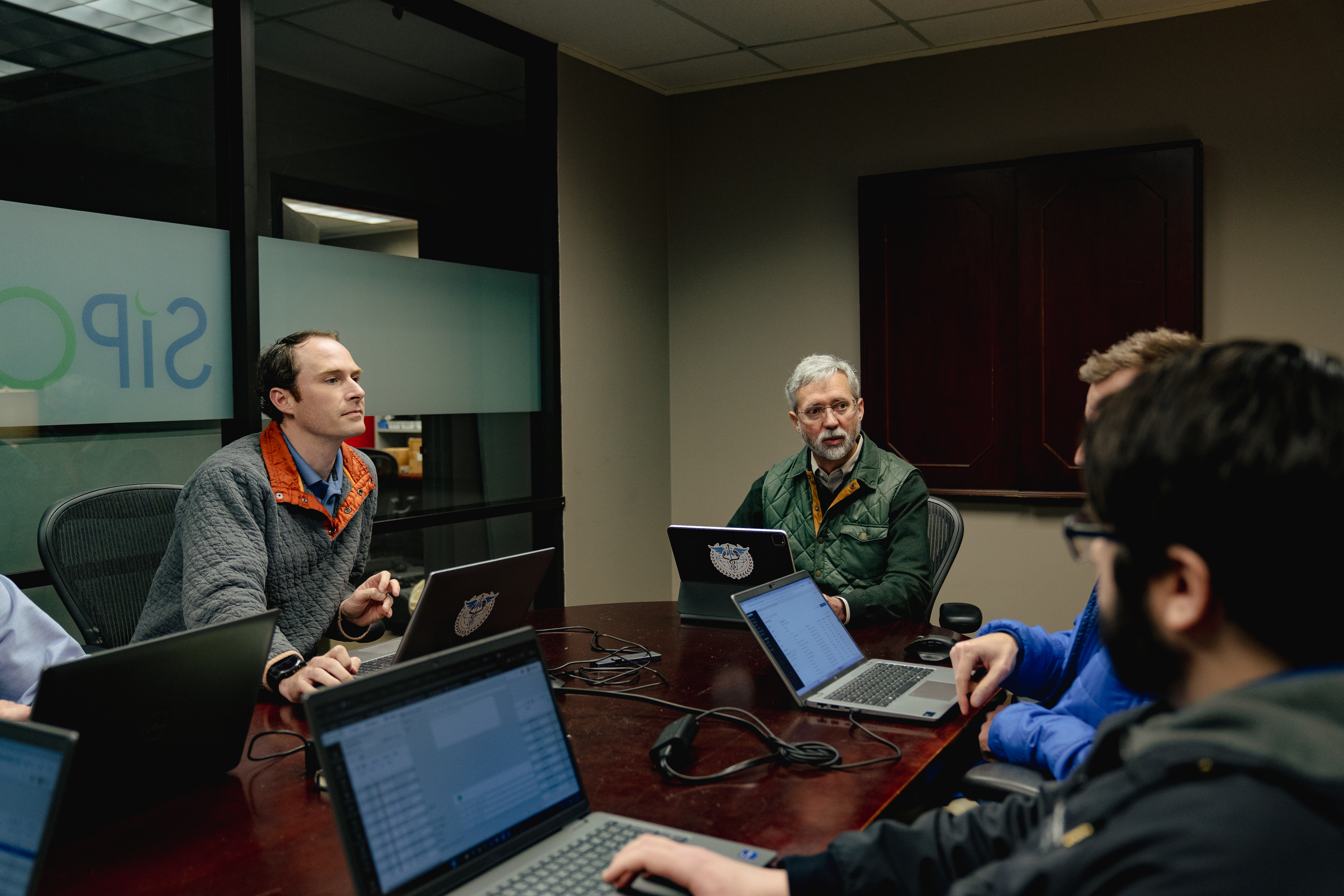 SIP Oasis team in a conference room working through laptops and discussion points
