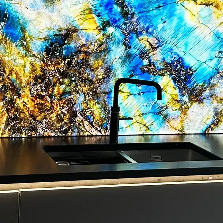 Luxury bathroom with LED backlit green onyx feature wall and illuminated glass shelving over a white bathtub