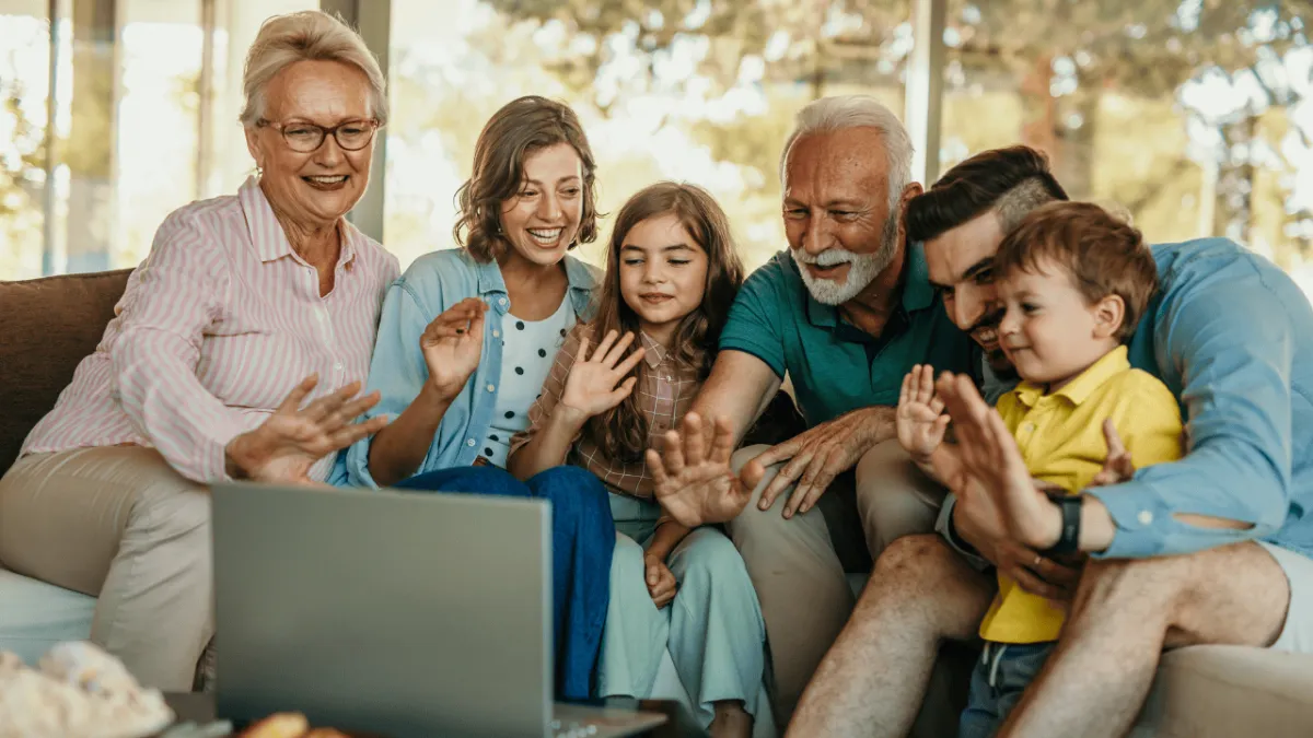 Multigenerational family gathered around a laptop, having a warm conversation about estate planning and legacy