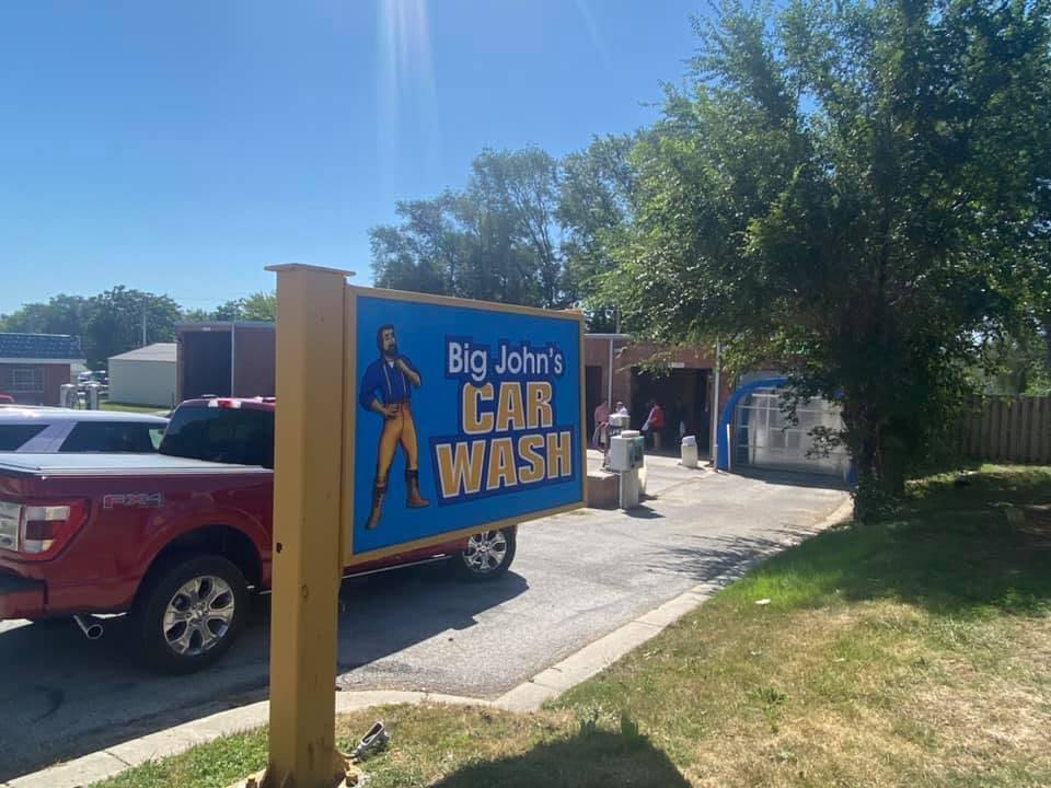 A well-lit car wash bay open 24/7