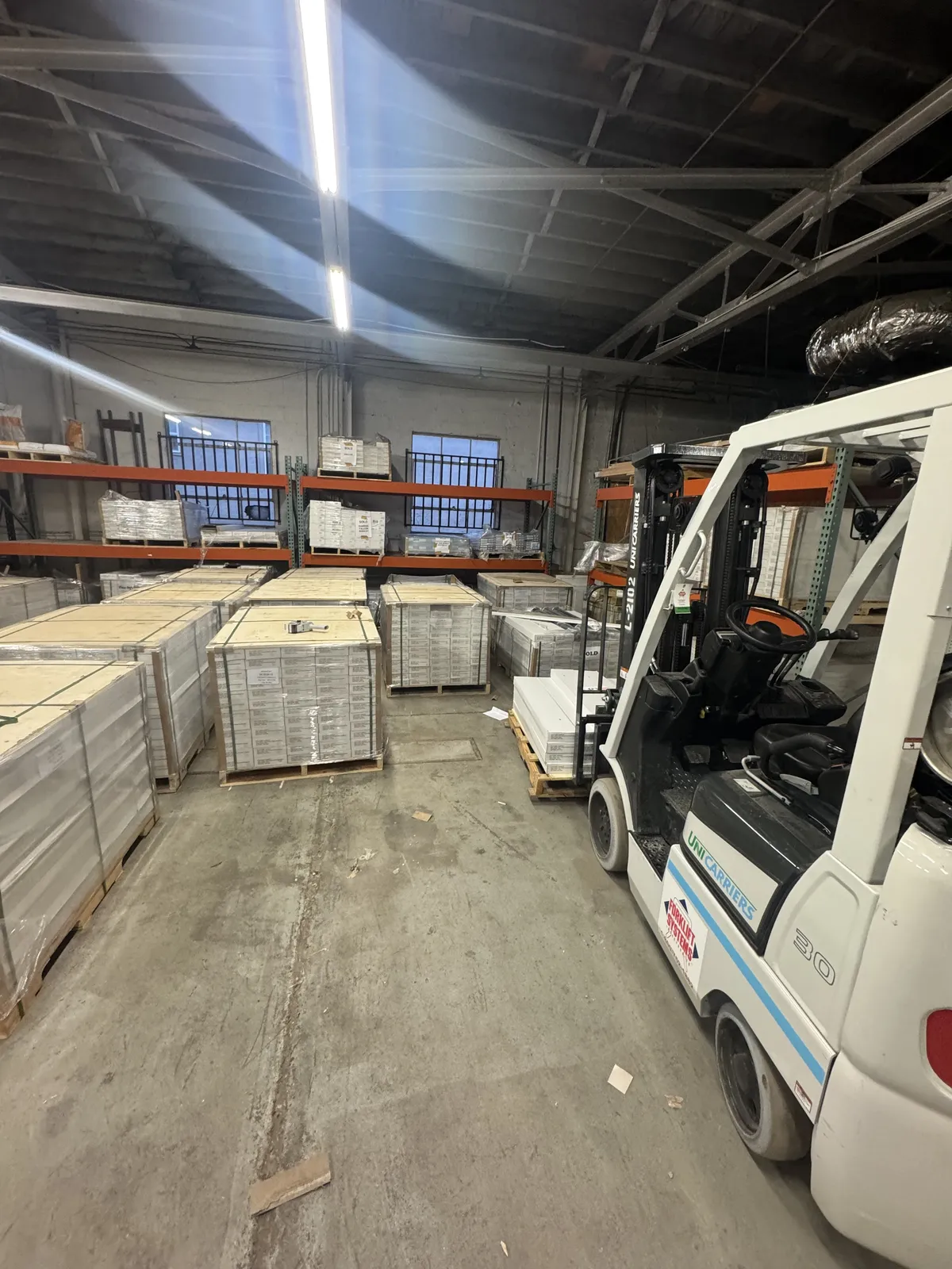 High-contrast commercial flooring warehouse distribution floor with stacked pallets