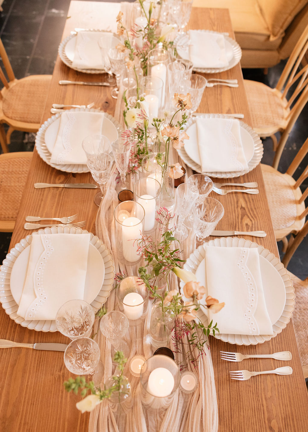 Round table set for a formal event with floral centerpiece.