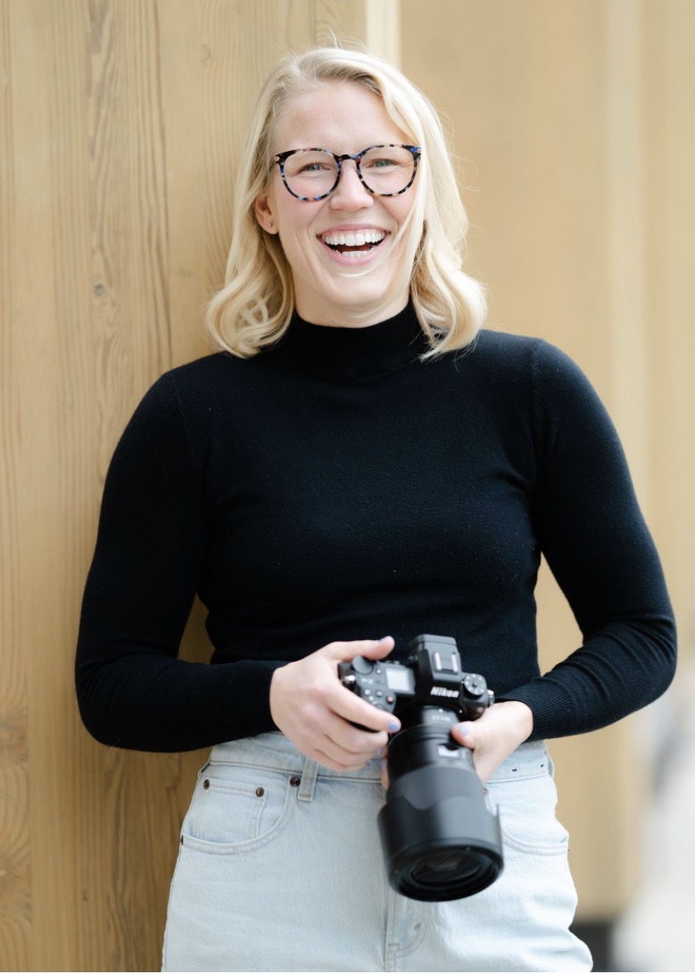 Female photographer laughing for the camera