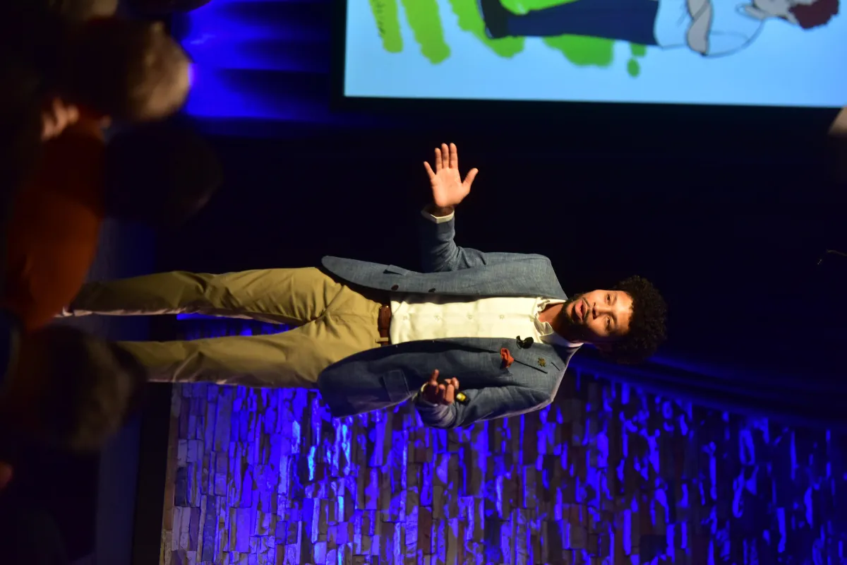 Shea Taylor gesturing while giving a speech