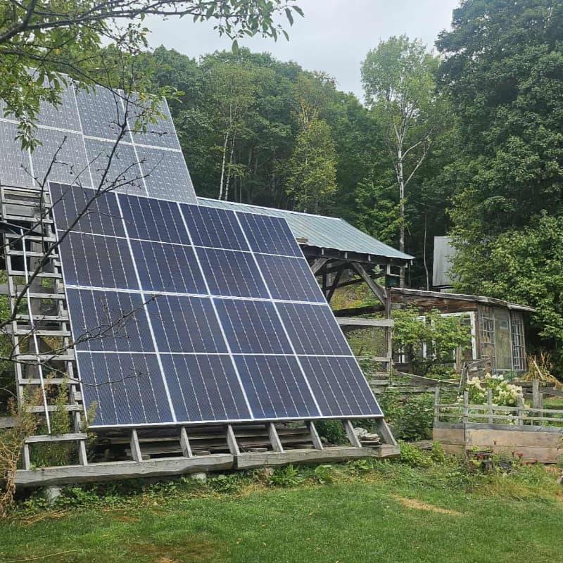 Solar panel installation at the Off Grid Ark in Quebec, part of the off-grid and solar education program teaching sustainable energy systems.