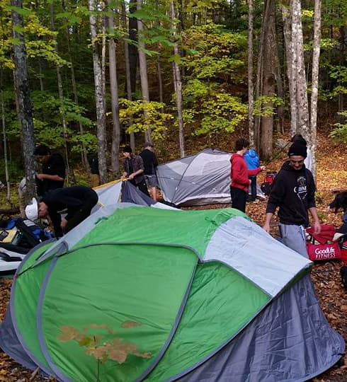 family wilderness camp tents set up in forest at The Off Grid Ark in Western Quebec”