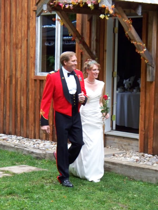 Bride walking with her father toward the ceremony at The Off Grid Ark wedding venue near Ottawa–Gatineau.