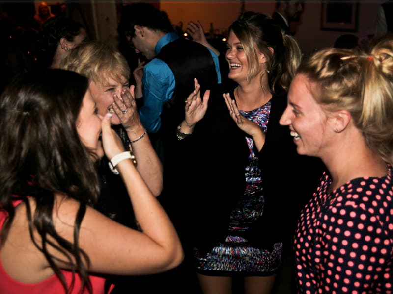 Guests dancing and laughing during an indoor wedding reception at The Off Grid Ark near Ottawa–Gatineau.