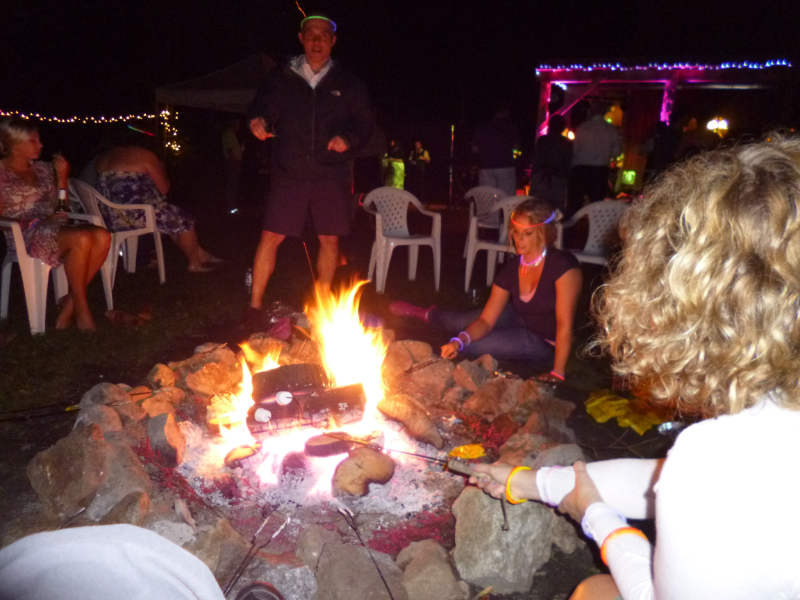 Guests gathered around an outdoor bonfire during an evening wedding reception at The Off Grid Ark near Ottawa–Gatineau.
