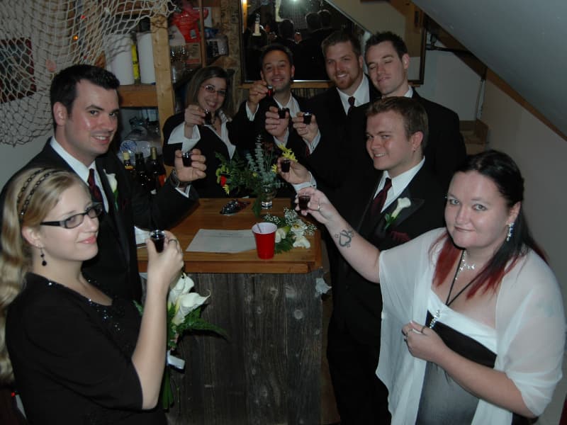 Wedding guests toasting together at a self-serve indoor bar during a reception at The Off Grid Ark near Ottawa–Gatineau.