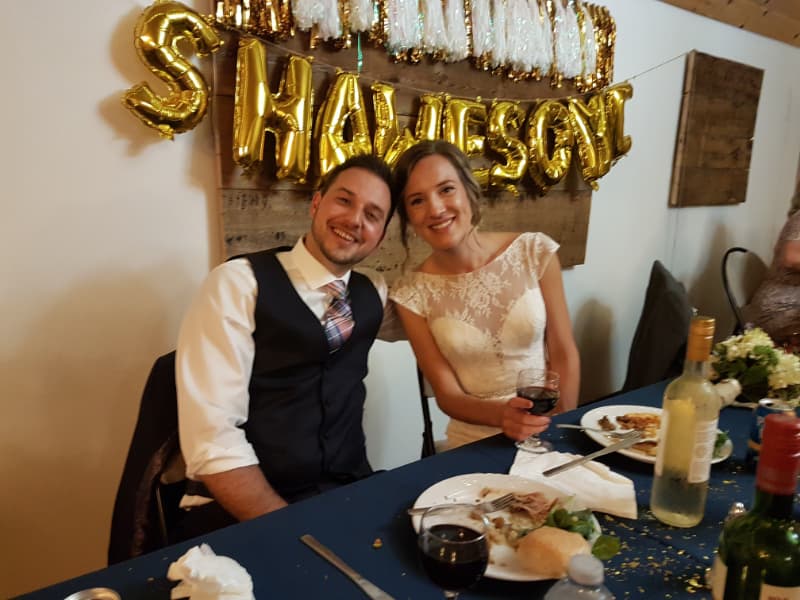 Bride and groom seated together during an indoor wedding reception at The Off Grid Ark near Ottawa–Gatineau.