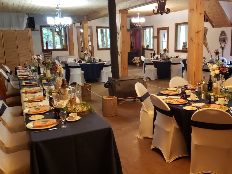 Indoor wedding reception dining tables set for guests at The Off Grid Ark near Ottawa–Gatineau.