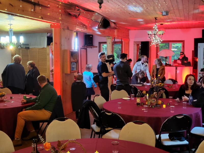 Guests mingling during an indoor wedding reception with evening lighting at The Off Grid Ark near Ottawa–Gatineau.
