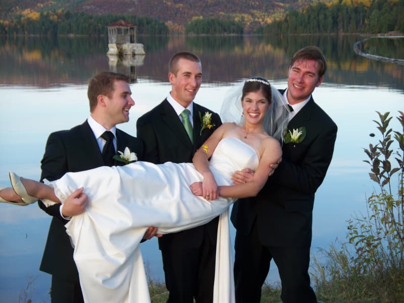 Wedding party posing by the Gatineau River fnear The Off Grid Ark in Western Quebec, close to Ottawa–Gatineau for a fun wedding photo