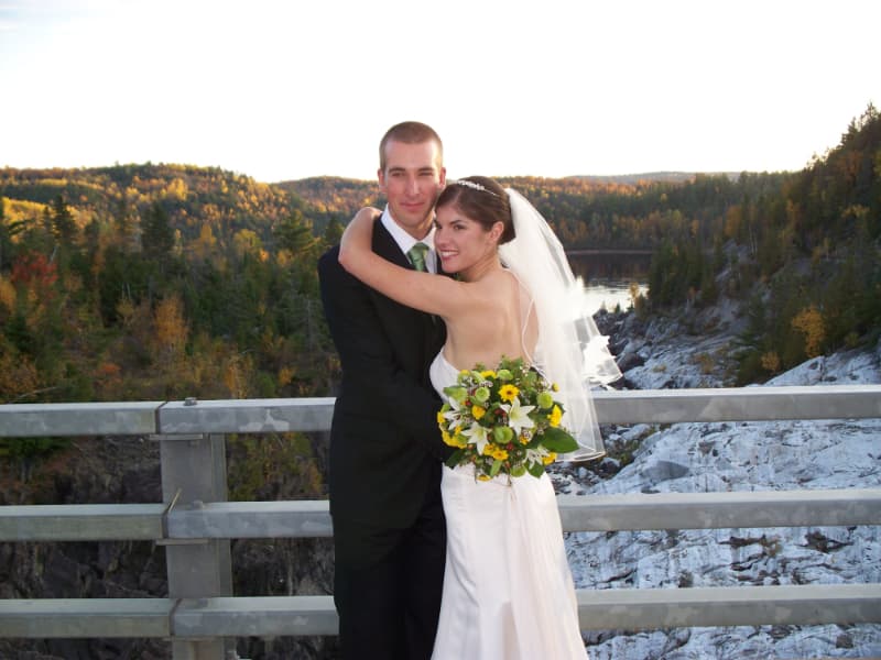 Bride and groom posing together at a scenic outdoor wedding photo location near The Off Grid Ark in Western Quebec, with forest and river valley views near Ottawa–Gatineau.