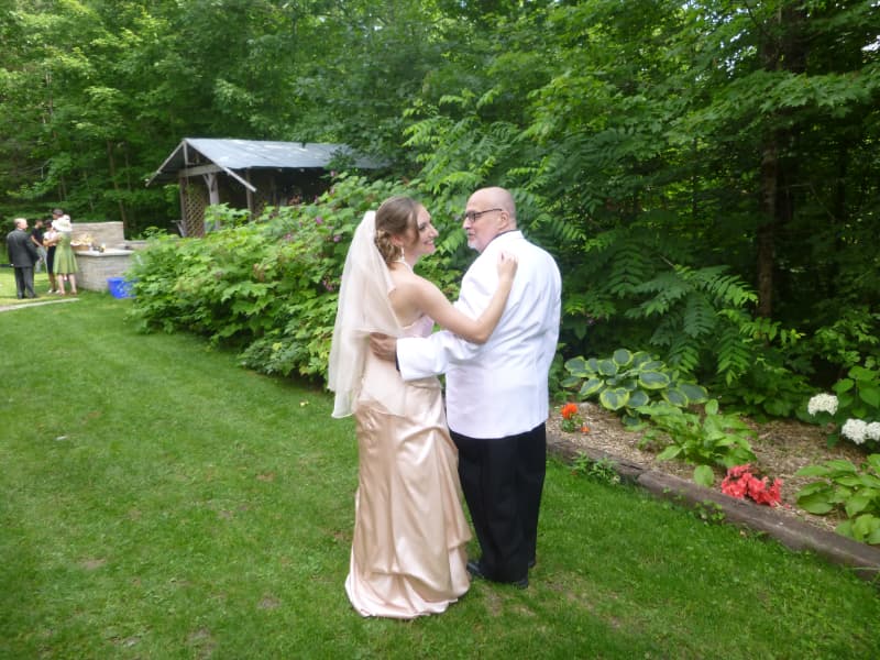 Personalized outdoor wedding ceremony at The Off Grid Ark near Ottawa–Gatineau, with the officiant wearing a Dr. Seuss hat during the vows in a forest setting