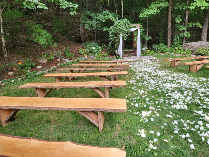 Personalized outdoor wedding ceremony at The Off Grid Ark near Ottawa–Gatineau, with the groom playing guitar during the vows in a forest setting.