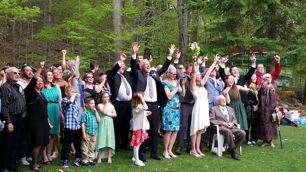 Wedding couple celebrating with family and friends in the forest at The Ark in Western Quebec.