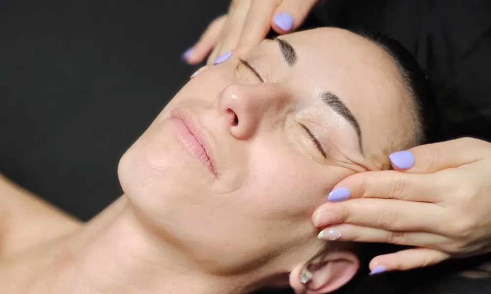 Relaxing facial massage helping with serums and treatments
