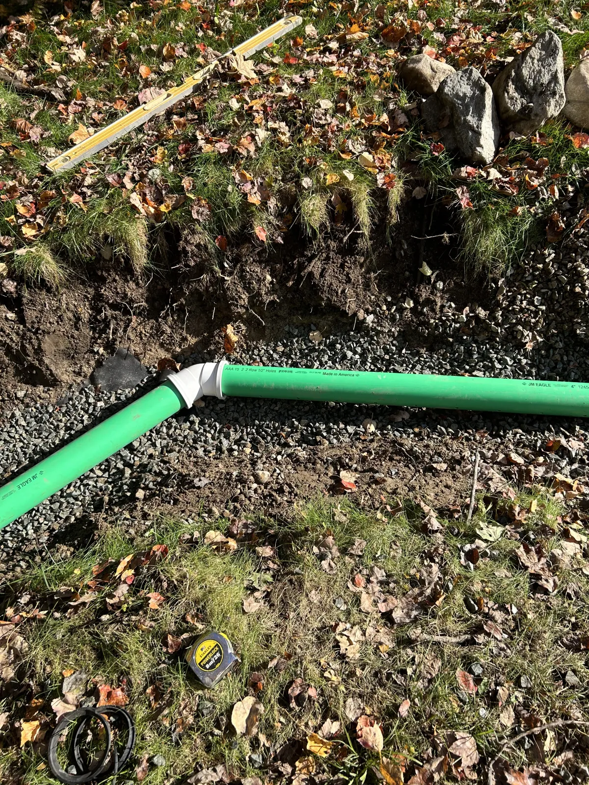 Underground drainage pipe installation to improve yard drainage and water flow