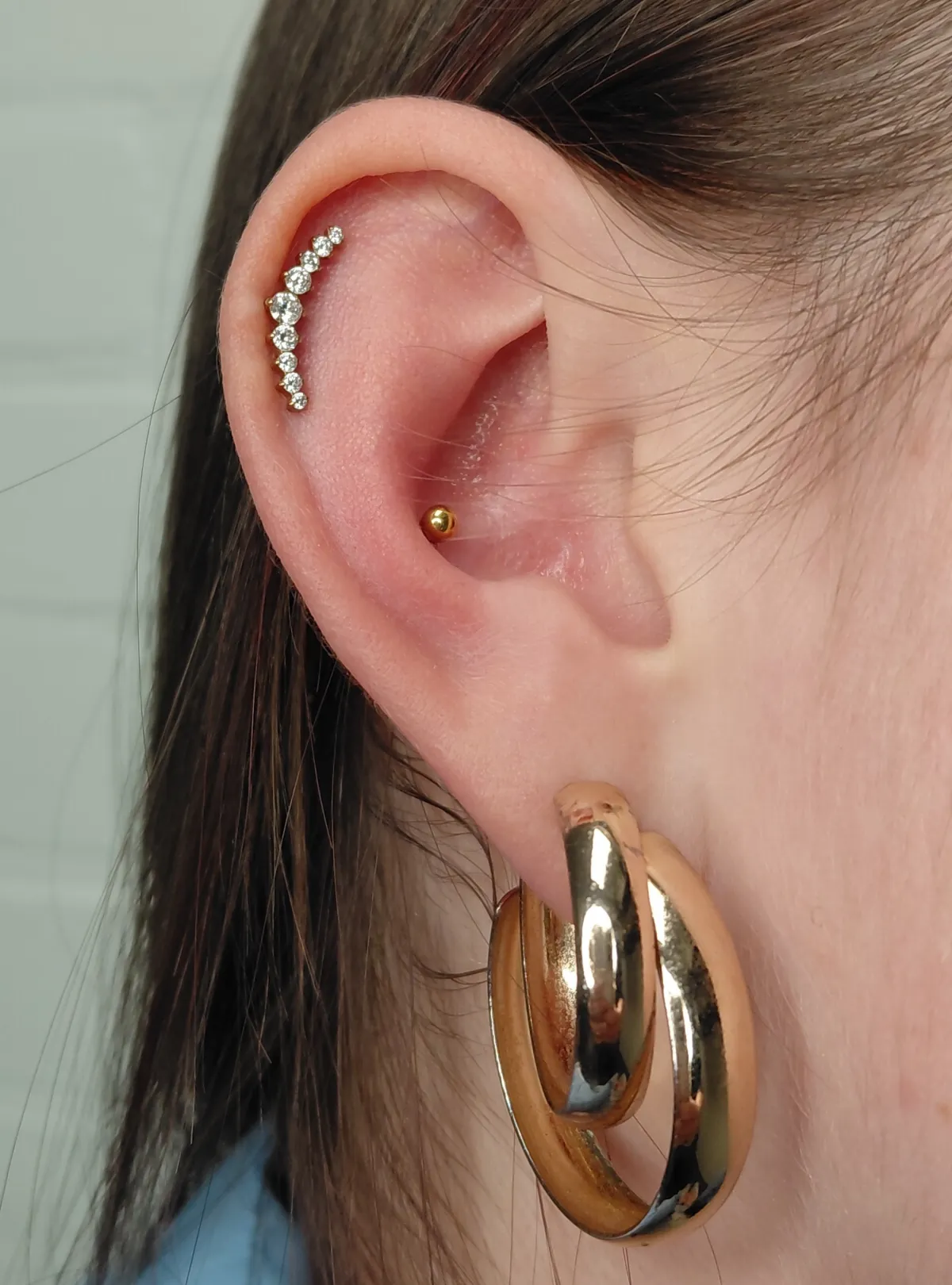 helix, conch piercing Deventer Iris Tattoo Art