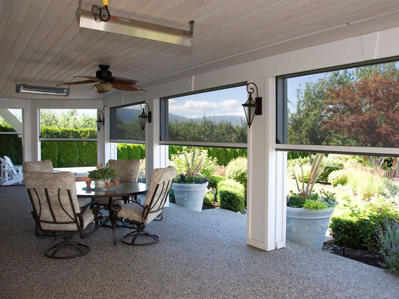 Project Gallery — Specified, Installed, Documented. Professionally certified outdoor patio enclosure with motorized solar screens, ceiling fan, infrared heater, and scenic mountain view — residential screen room installation written into construction documents by a certified team