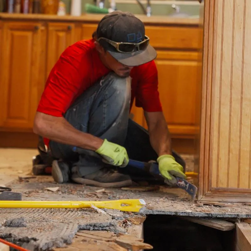 The underbelly of a mobile home in Bradenton, Florida, being sealed with a new ground moisture barrier to prevent rot and pests.
