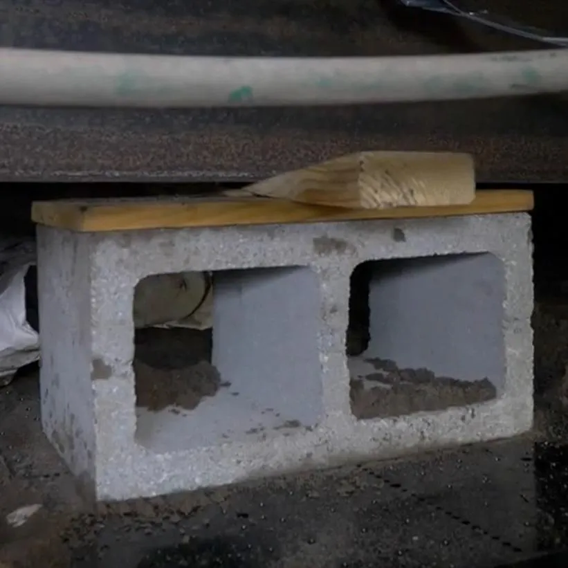 The Vapor Barrier Leesburg team using concrete blocks to re-level a manufactured home in Leesburg, Florida.