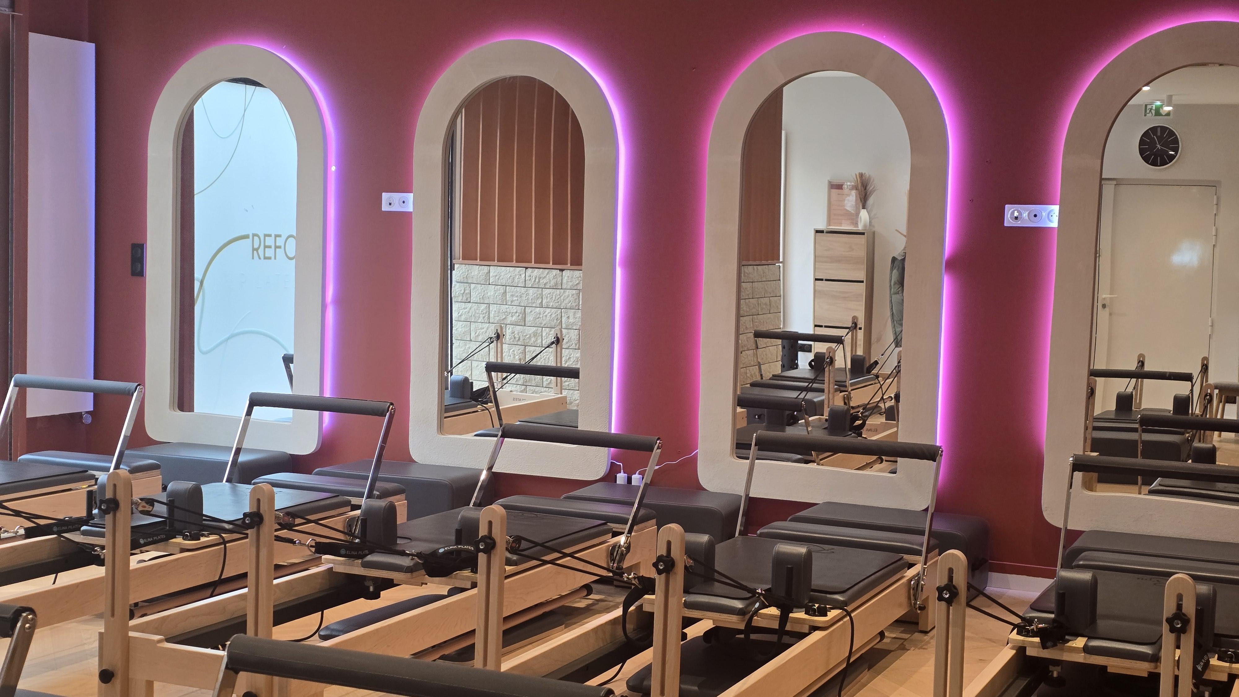 Modern yoga studio with large windows and mats.