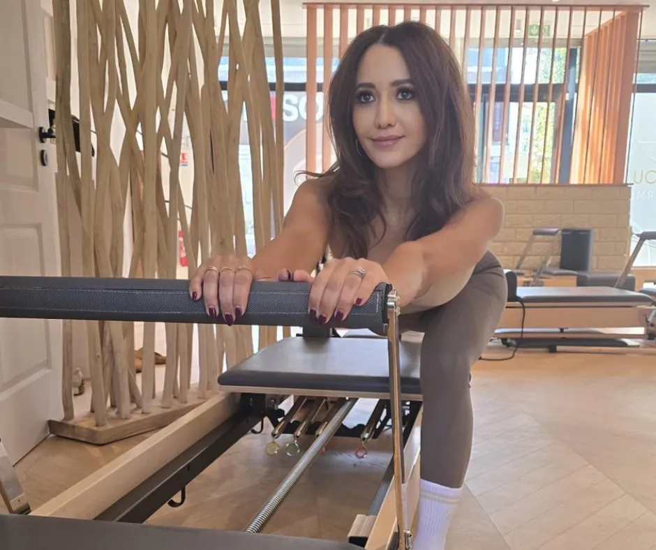 woman sitting on dock bridge near lake during daytime