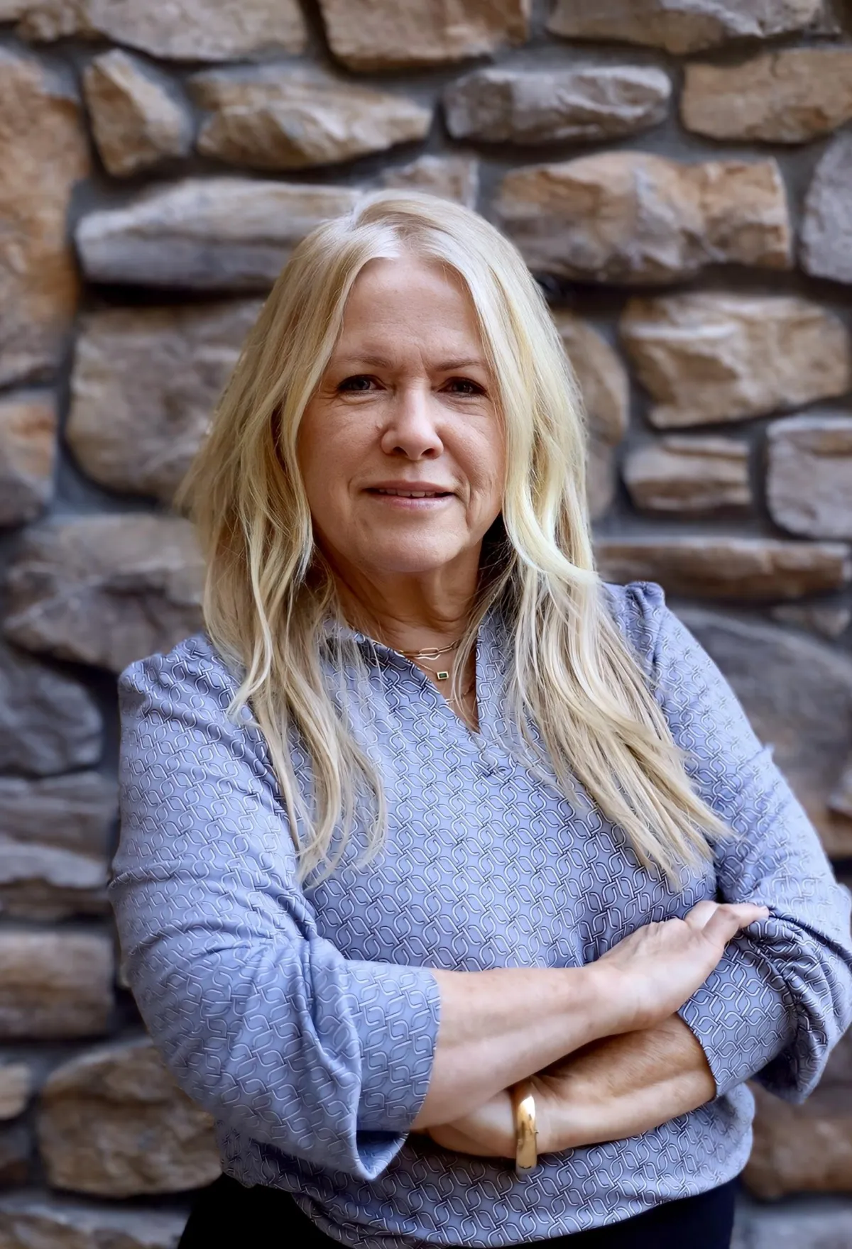 Ingrid, Concierge Placement Agent, professional headshot with long blonde hair, wearing a patterned blue top.