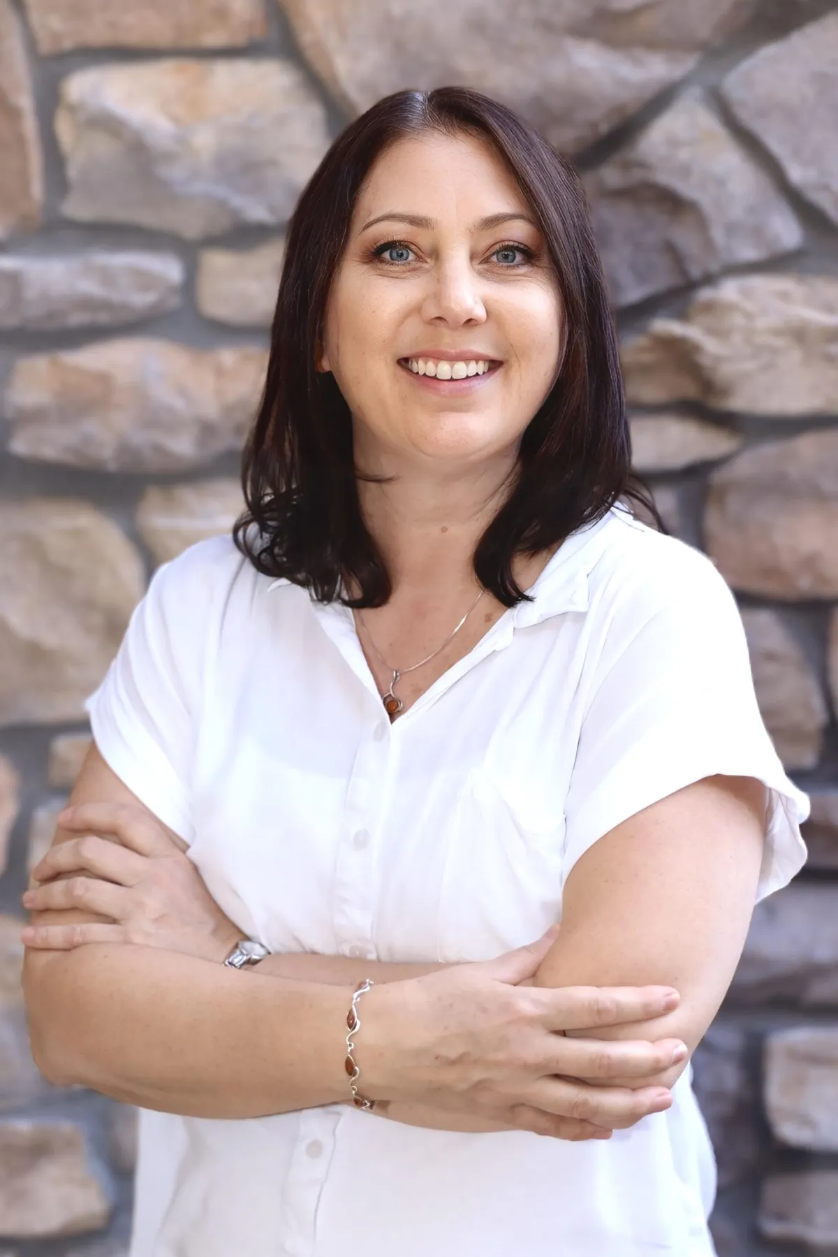 Greg Sarlo, Founder and CEO, professional headshot smiling in a light blue blazer and white shirt.