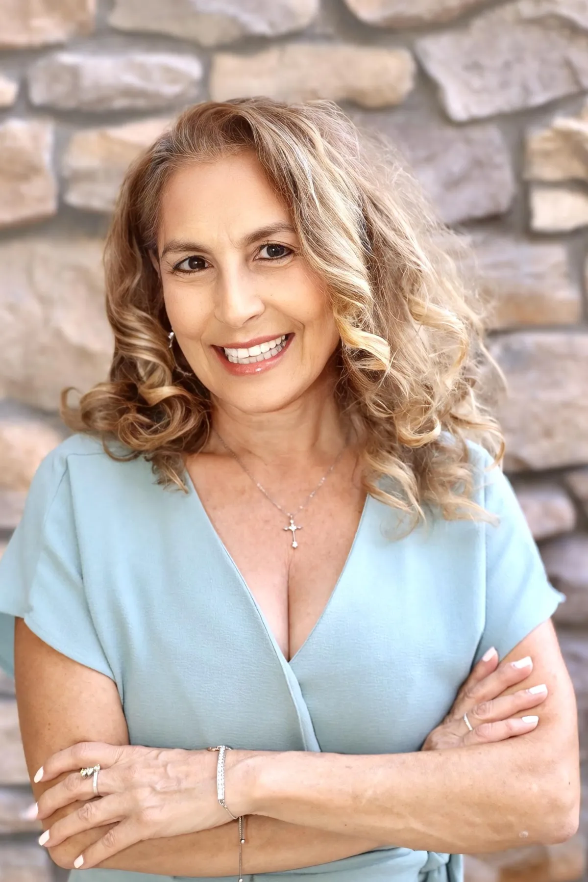 Ingrid, Concierge Placement Agent, professional headshot with long blonde hair, wearing a patterned blue top.