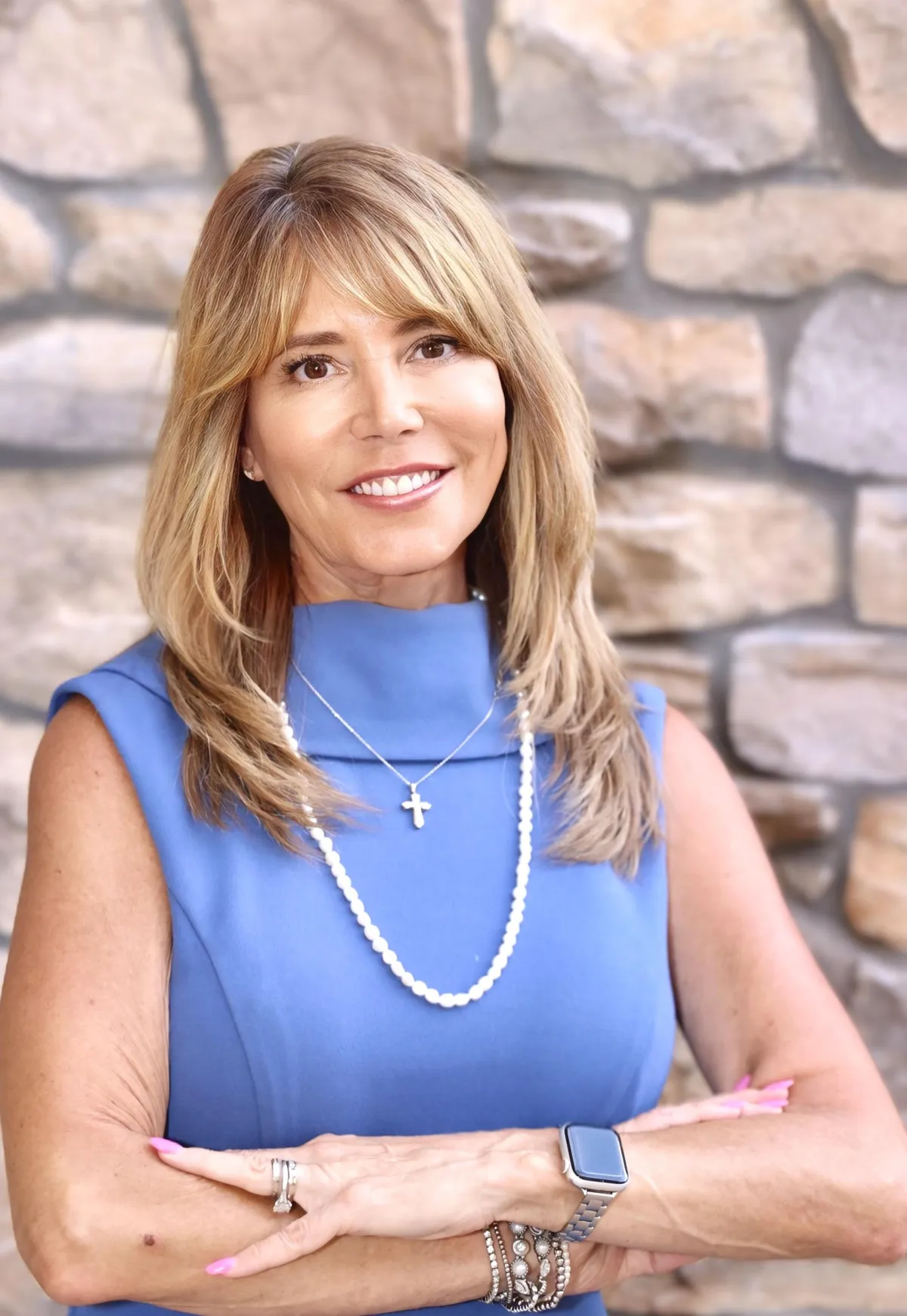 Greg Sarlo, Founder and CEO, professional headshot smiling in a light blue blazer and white shirt.
