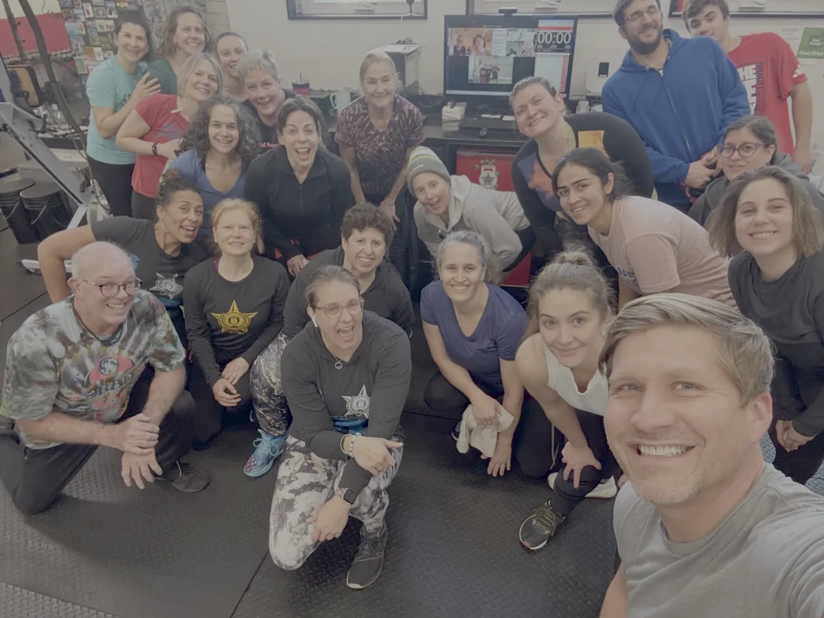 Group fitness clients smiling together after a training session at Urban Athlete in Philadelphia PA